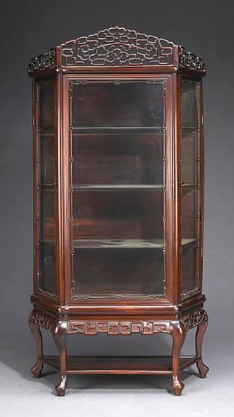 Appraisal: A hardwood and glass two-section curio cabinet Late Qing Early