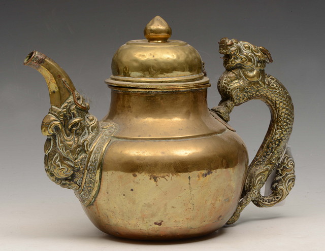 Appraisal: A LARGE TIBETAN TEAPOT with the handle being a stylized