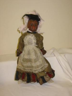 Appraisal: A bisque head Mulatto girl doll with fixed brown glass