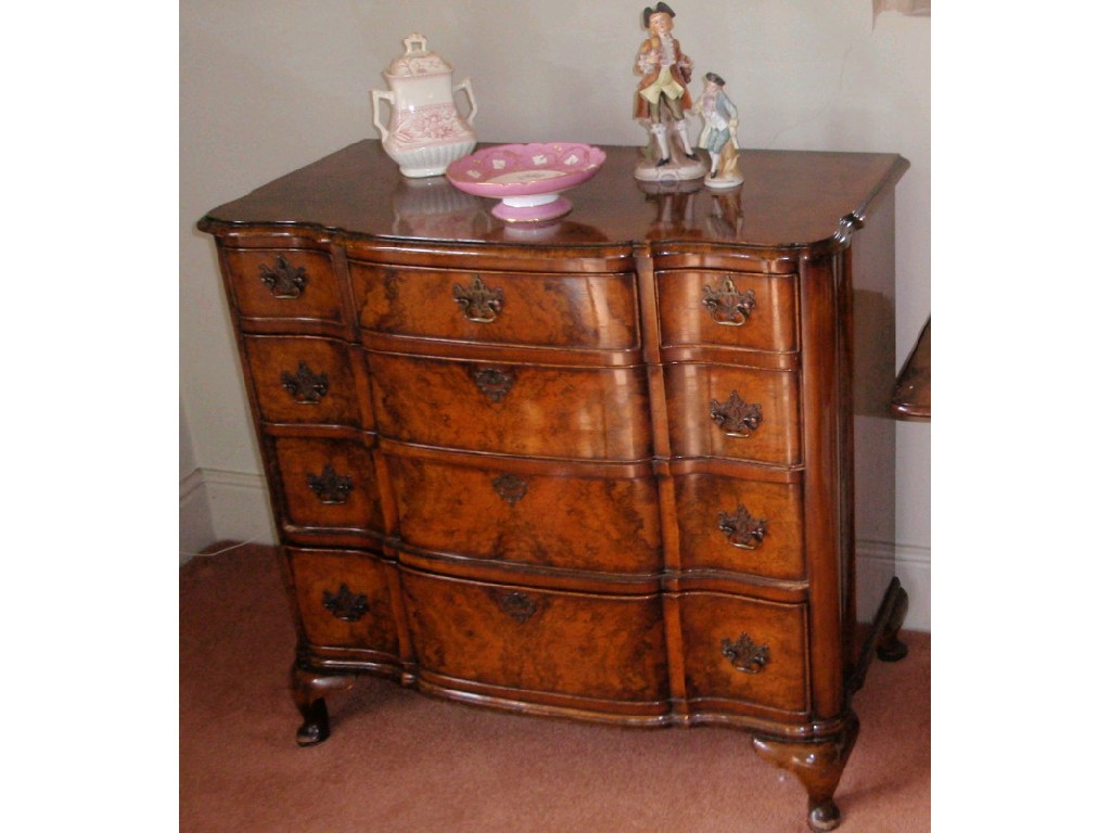 Appraisal: A quality reproduction figured walnut serpentine chest of three short