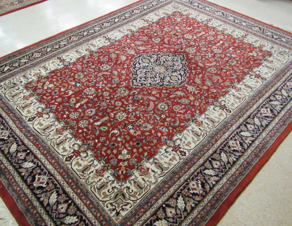 Appraisal: HAND KNOTTED ORIENTAL CARPET Indo-Persian overall floral design on red