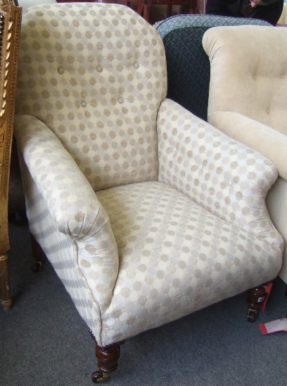 Appraisal: A Victorian walnut framed button back armchair with outswept arms