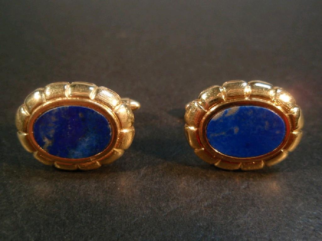 Appraisal: A pair of oval cuff links set with Lapis Lazuli