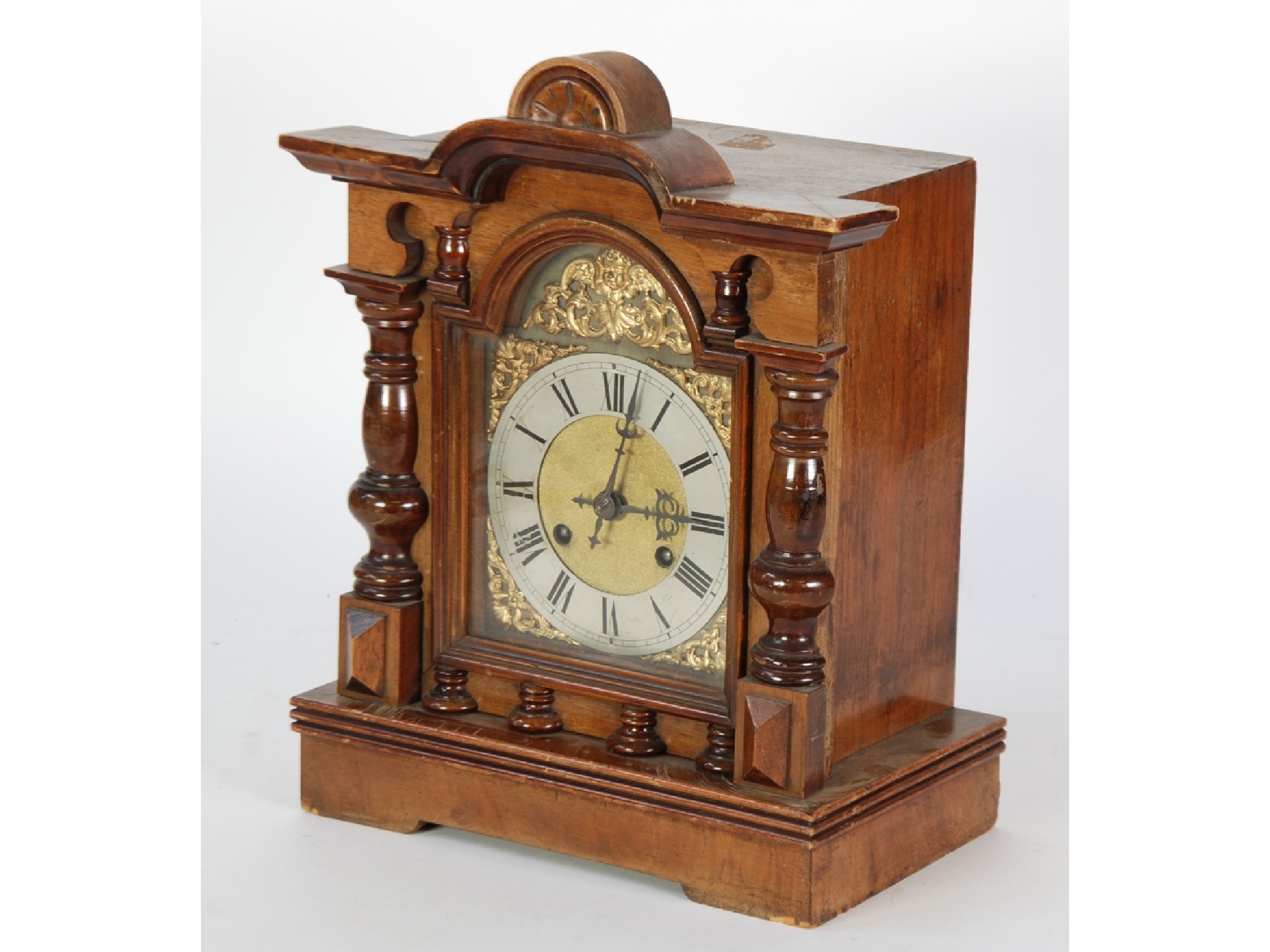 Appraisal: EARLY TWENTIETH CENTURY WALNUTWOOD MANTEL CLOCK the arched dial with