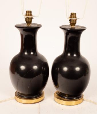 Appraisal: A pair of ebonised vase-shaped table lights with shades cm