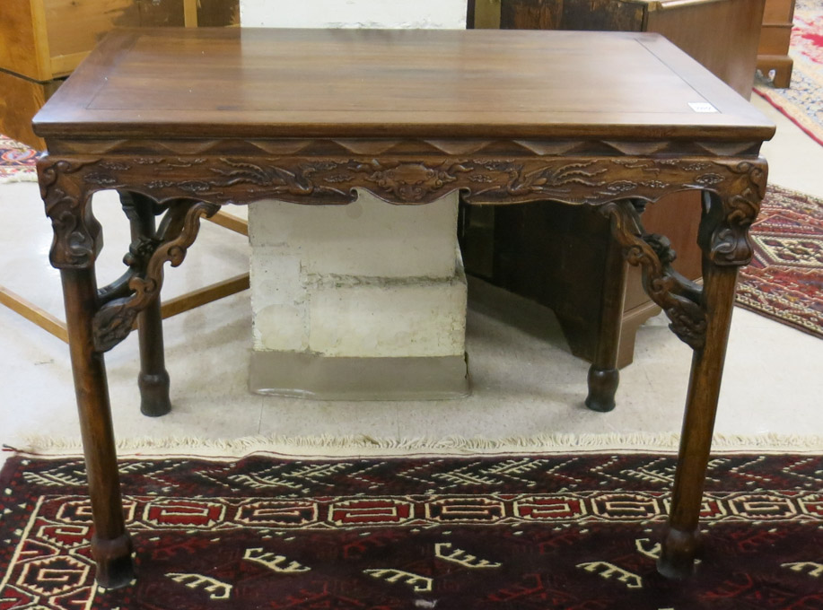 Appraisal: CHINESE CARVED HUALIMU CENTER TABLE having a rectangular top overhanging