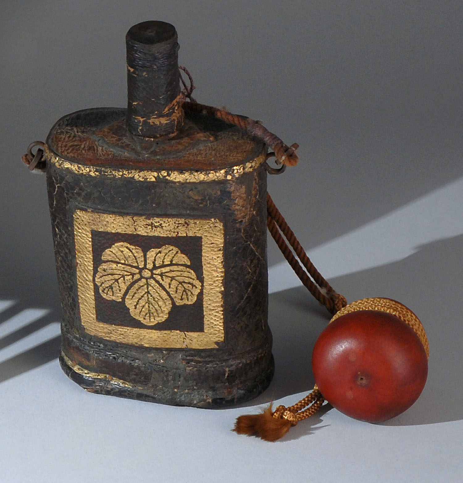 Appraisal: JAPANESE LEATHER POWDER HORN Early th CenturyIn modified cylinder form