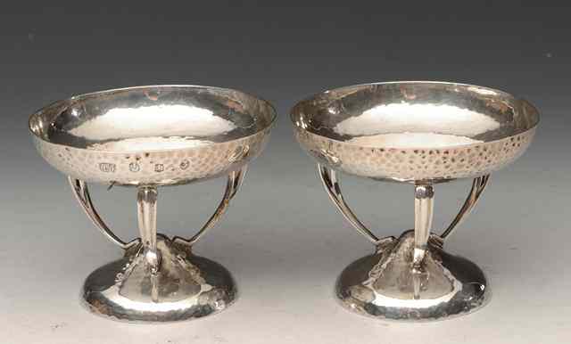 Appraisal: A PAIR OF ARTS CRAFTS SILVER DISHES with beaten bowls