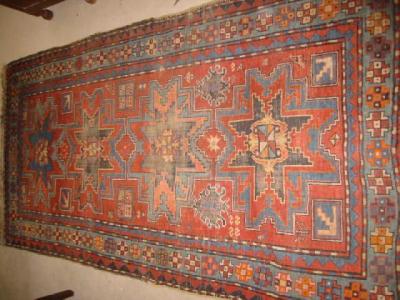 Appraisal: A KAZAK RUG the red field with four Lesghi stars