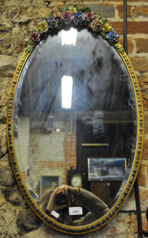 Appraisal: A Barbola framed oval wall mirror with bevelled plate