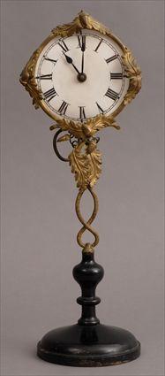 Appraisal: BIEDERMEIER-STYLE GILT-METAL AND EBONIZED WOOD CLOCK The in paper face