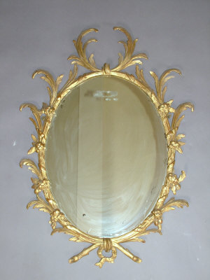 Appraisal: A giltwood Regency wall mirror the oval mirror in acanthus