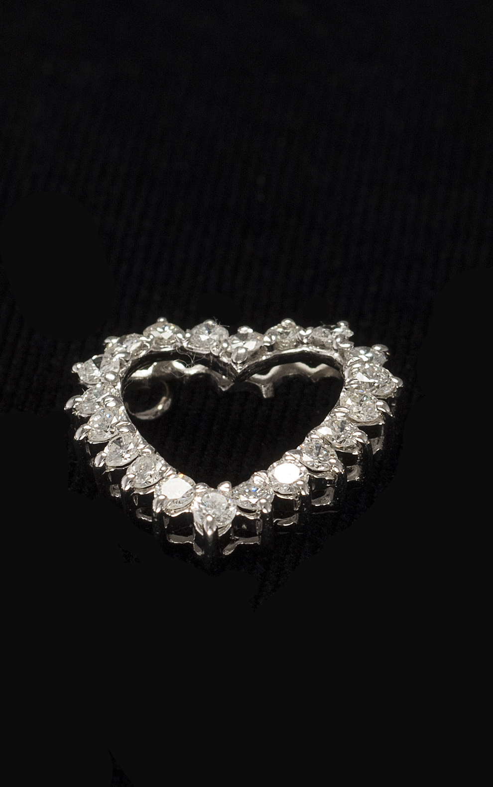 Appraisal: KT WHITE GOLD AND DIAMOND PENDANT In heart shape Set