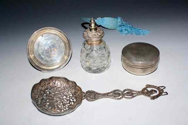 Appraisal: A SILVER MOUNTED GLASS ATOMIZER with pressed scroll decoration high