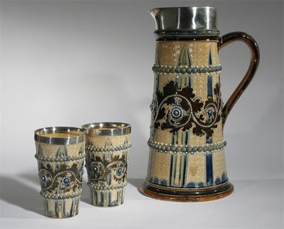 Appraisal: A large Doulton Lambeth stoneware jug and two beakers by