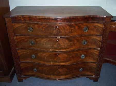 Appraisal: A Victorian mahogany serpentine front chest of four drawers flanked