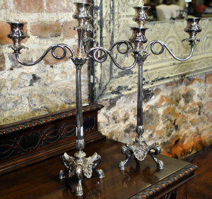 Appraisal: A pair of Victorian ep Etruscan style three-sconce candelabra on