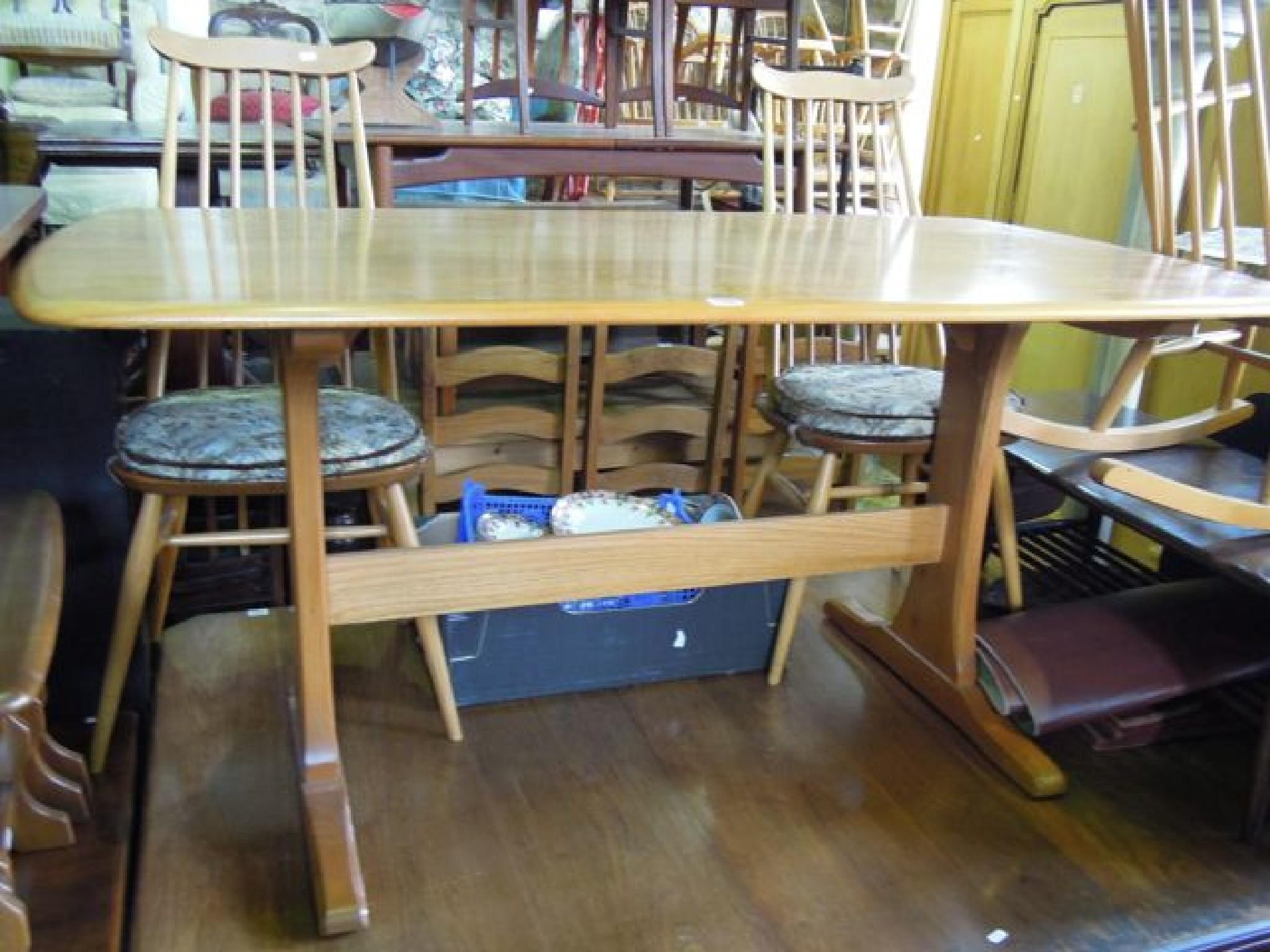 Appraisal: An Ercol light elm refectory table raised on shaped supports