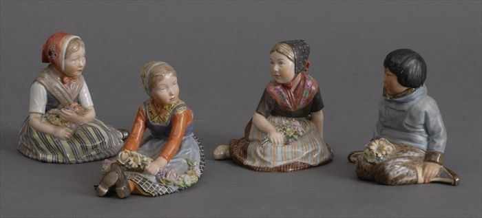 Appraisal: FOUR ROYAL COPENHAGEN FIGURES OF SEATED CHILDREN IN NATIONAL DRESS