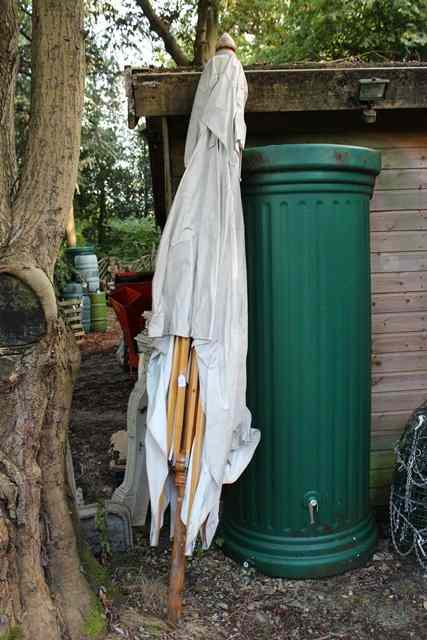 Appraisal: A LARGE WHITE CANVAS COVERED PARASOL