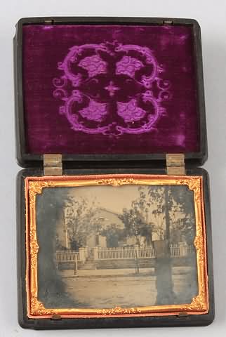 Appraisal: Quarter plate ambrotype of house with picket fence and street