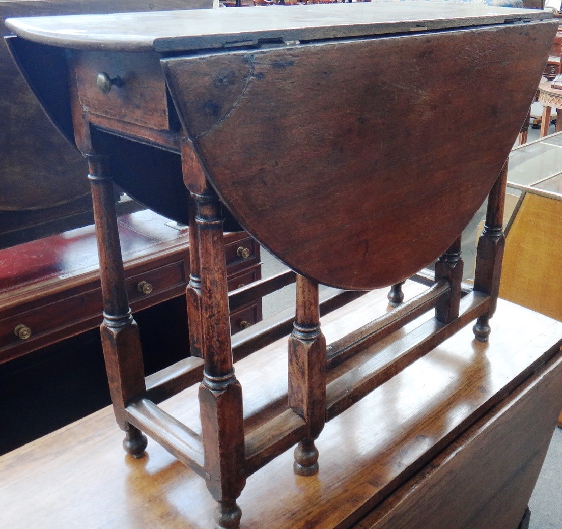 Appraisal: An th century drop flap table the oval top over