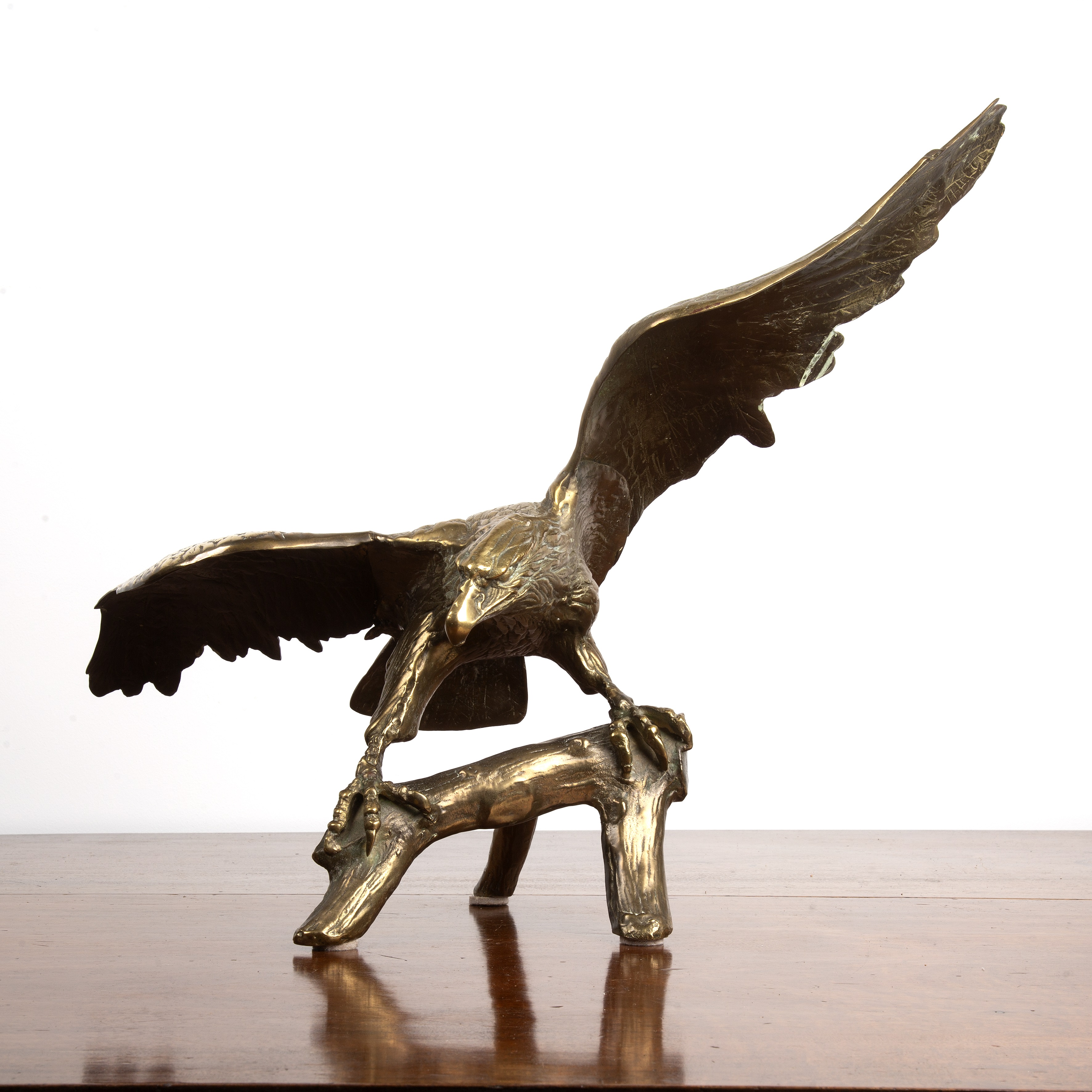 Appraisal: Gilded bronze eagledepicted perched on a tree branch with its