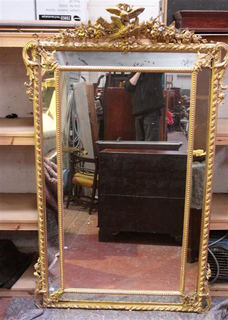 Appraisal: A large th century giltwood framed overmantel mirror the rectangular