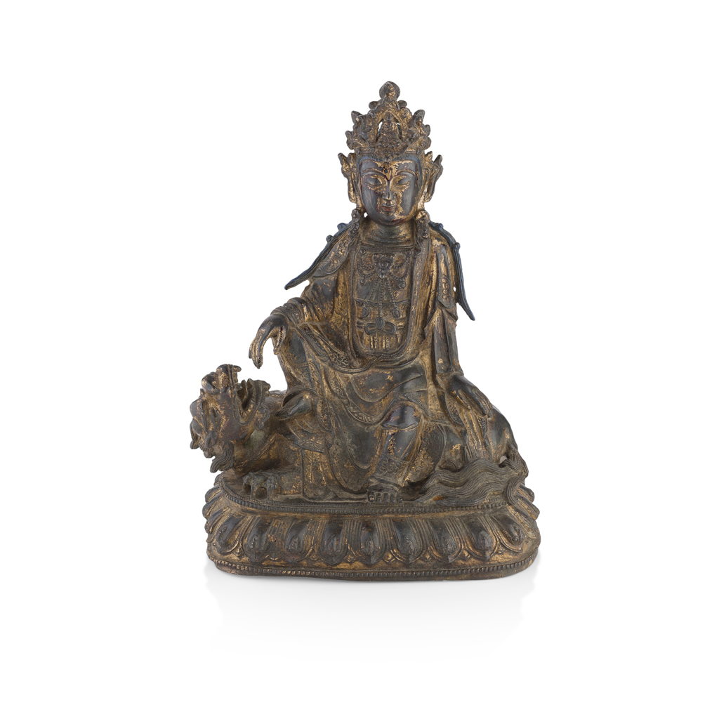 Appraisal: PARCEL-GILT BRONZE FIGURE OF GUANYIN the bodhisattva shown seated in