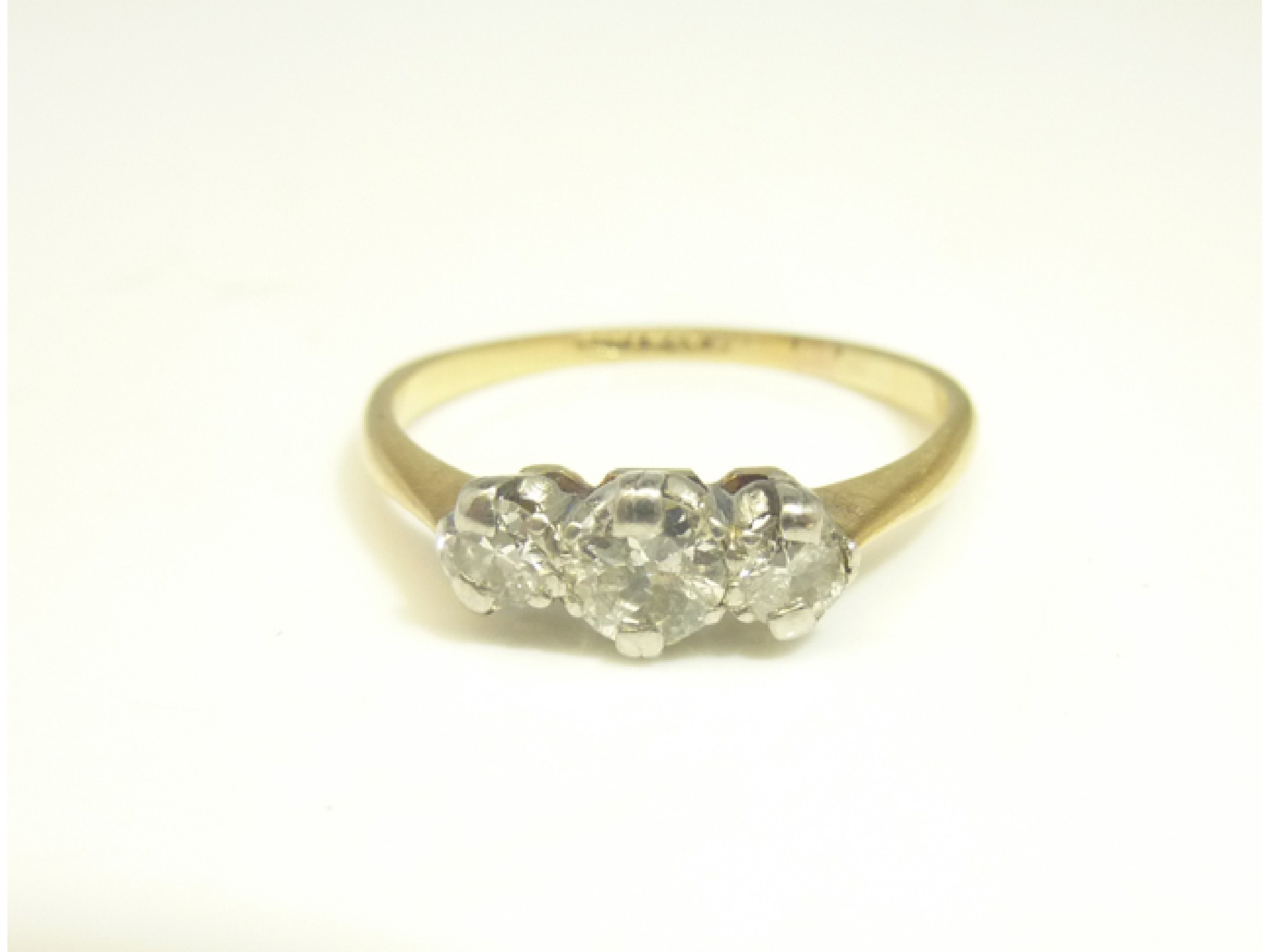 Appraisal: A three-stone diamond ring centred with an old brilliant-cut diamond