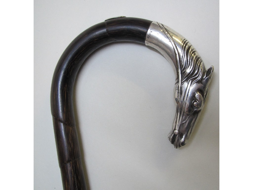 Appraisal: A continental silver mounted walking stick the curved handle mounted