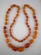 Appraisal: A graduated amber bead necklace largest bead approx x mm