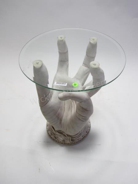 Appraisal: A modern end table 'hand' motif base with round glass