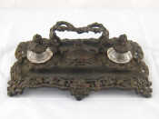 Appraisal: An imposing cast iron inkstand having handle two cut glass