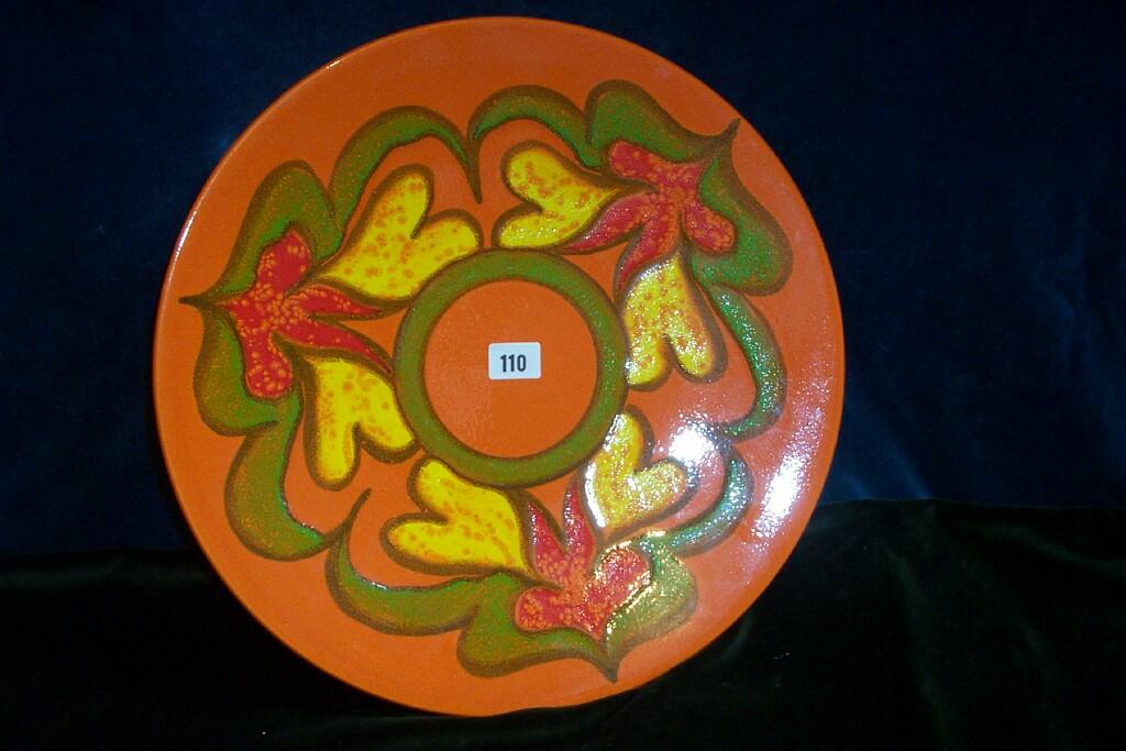 Appraisal: An orange ground Poole pottery Delphis charger by Judie Evans