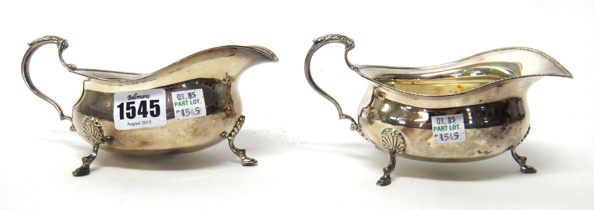 Appraisal: A pair of silver sauceboats each with a scrolling handle