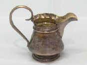 Appraisal: A Russian silver cream jug the conical body on spread