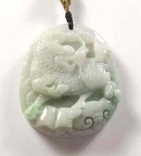 Appraisal: CHINESE JADEITE CARVED HEAVY OVAL PENDANT In deep relief a