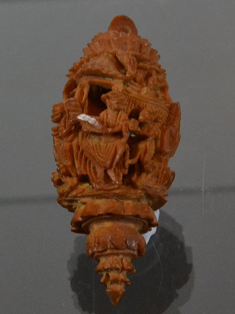 Appraisal: A SMALL CHINESE COQUILLA NUT depicting Chinese figures under a