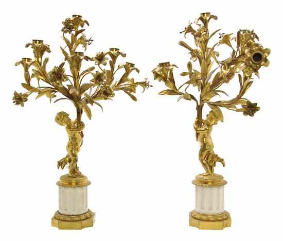 Appraisal: A Pair of French Gilt Bronze Figural Candelabra each cast