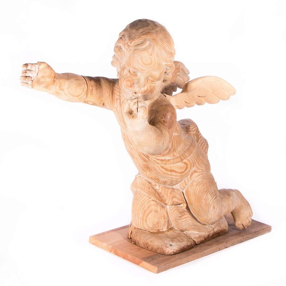 Appraisal: A carved wood cherub A th century carved wood cherub