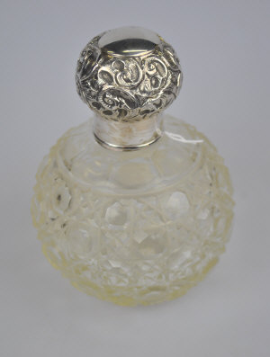 Appraisal: An Edwardian hobnail-cut glass globular scent bottle with silver bun