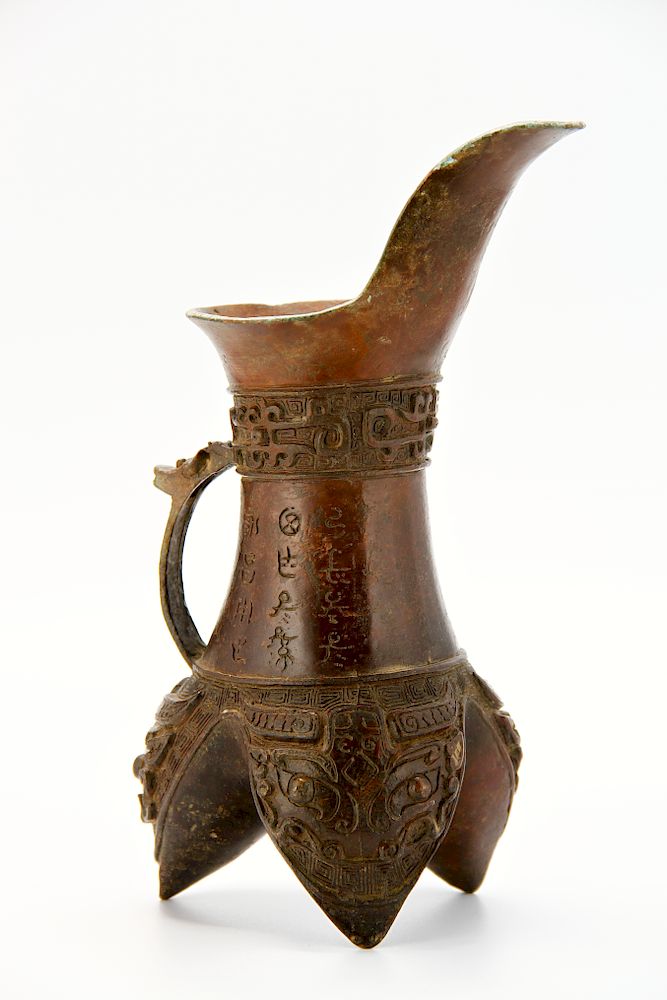 Appraisal: Bronze Wine Vessel Of archaistic form the cylindrical body supported