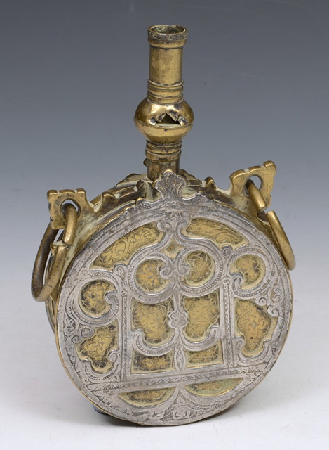 Appraisal: AN ISLAMIC WHITE METAL FLASK with ring handles and embossed