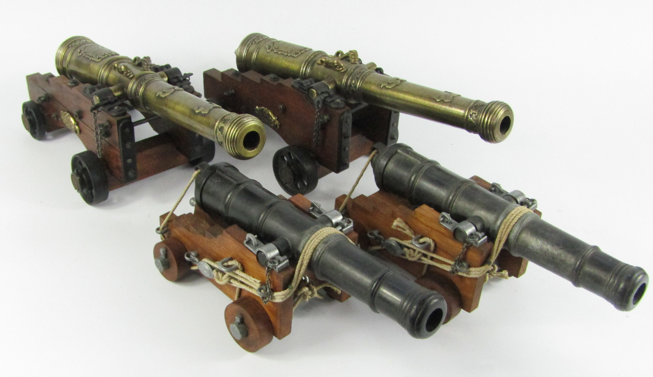 Appraisal: A pair of replica brass table cannons on oak carriages