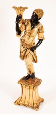 Appraisal: A Venetian style figure of a blackamoor modelled holding a