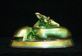 Appraisal: A Zsolnay green metallic luster glazed figure group of two