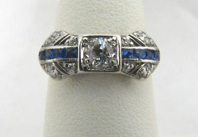 Appraisal: Platinum diamond and sapphire bow ring with calibre square cut