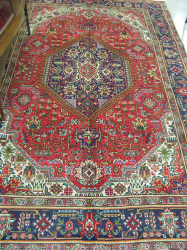 Appraisal: PERSIAN TABRIZ CARPET hand knotted in a stylized floral design