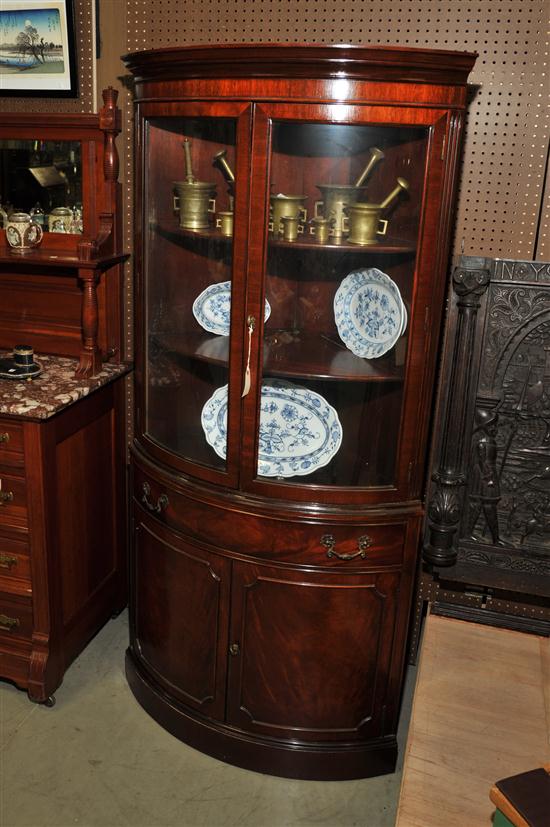 Appraisal: WHITE FURNITURE CO CORNER CUPBOARD Mahogany veneered barrel form cupboard